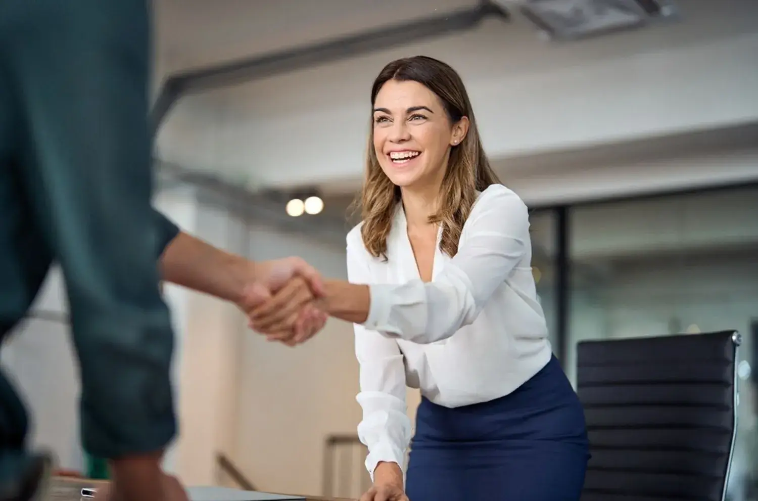 happy mid aged business woman manager handshaking greeting client in office smiling female
