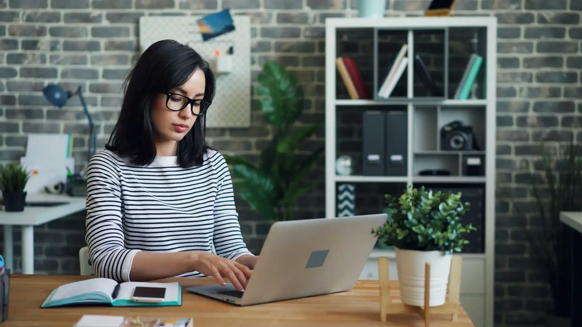 young professional business woman working on a laptop