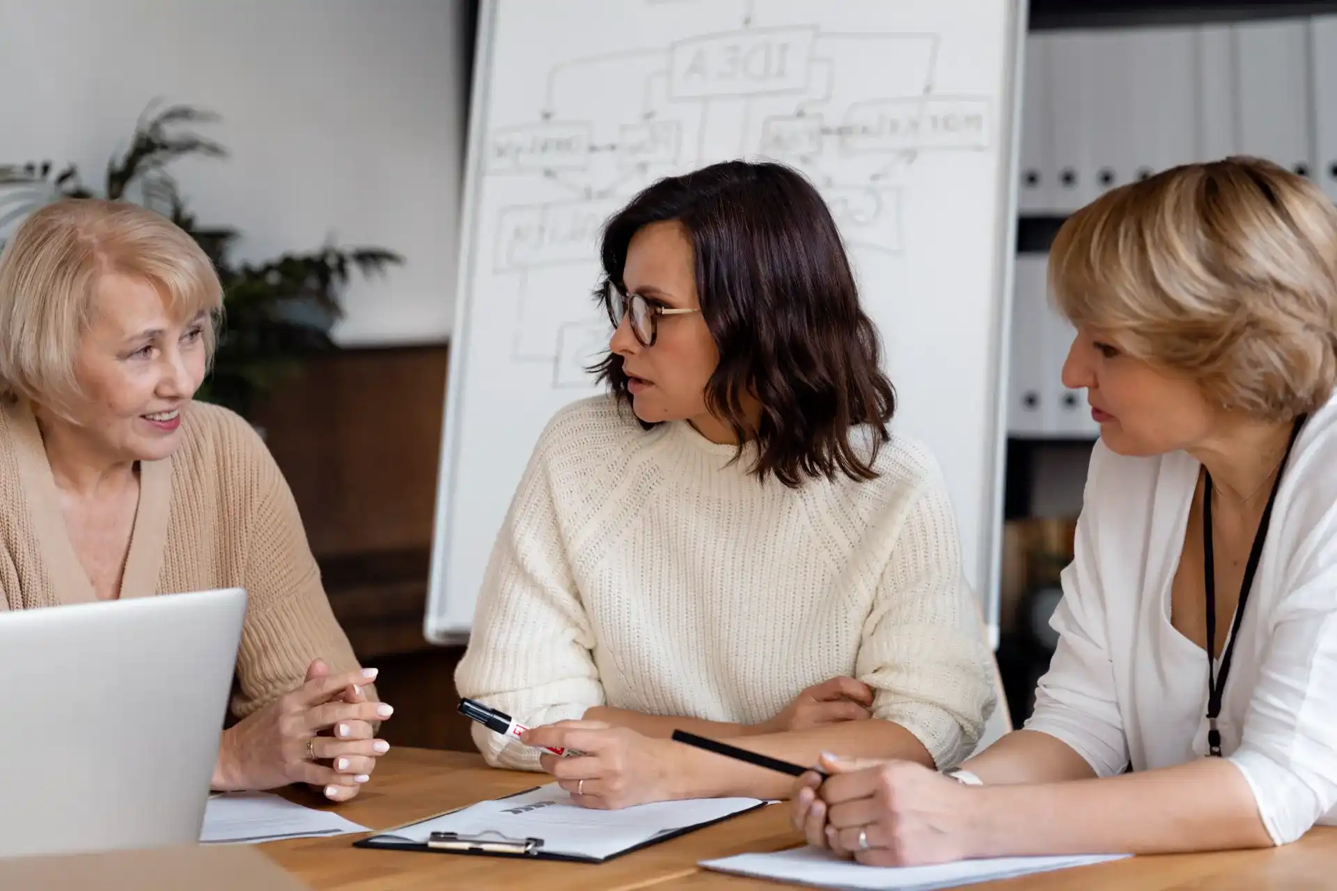 business women discussing table