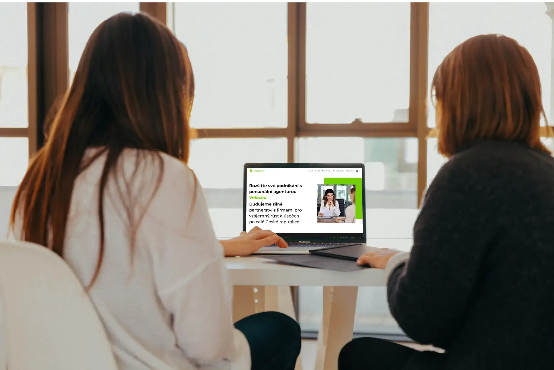 young women dicussing table